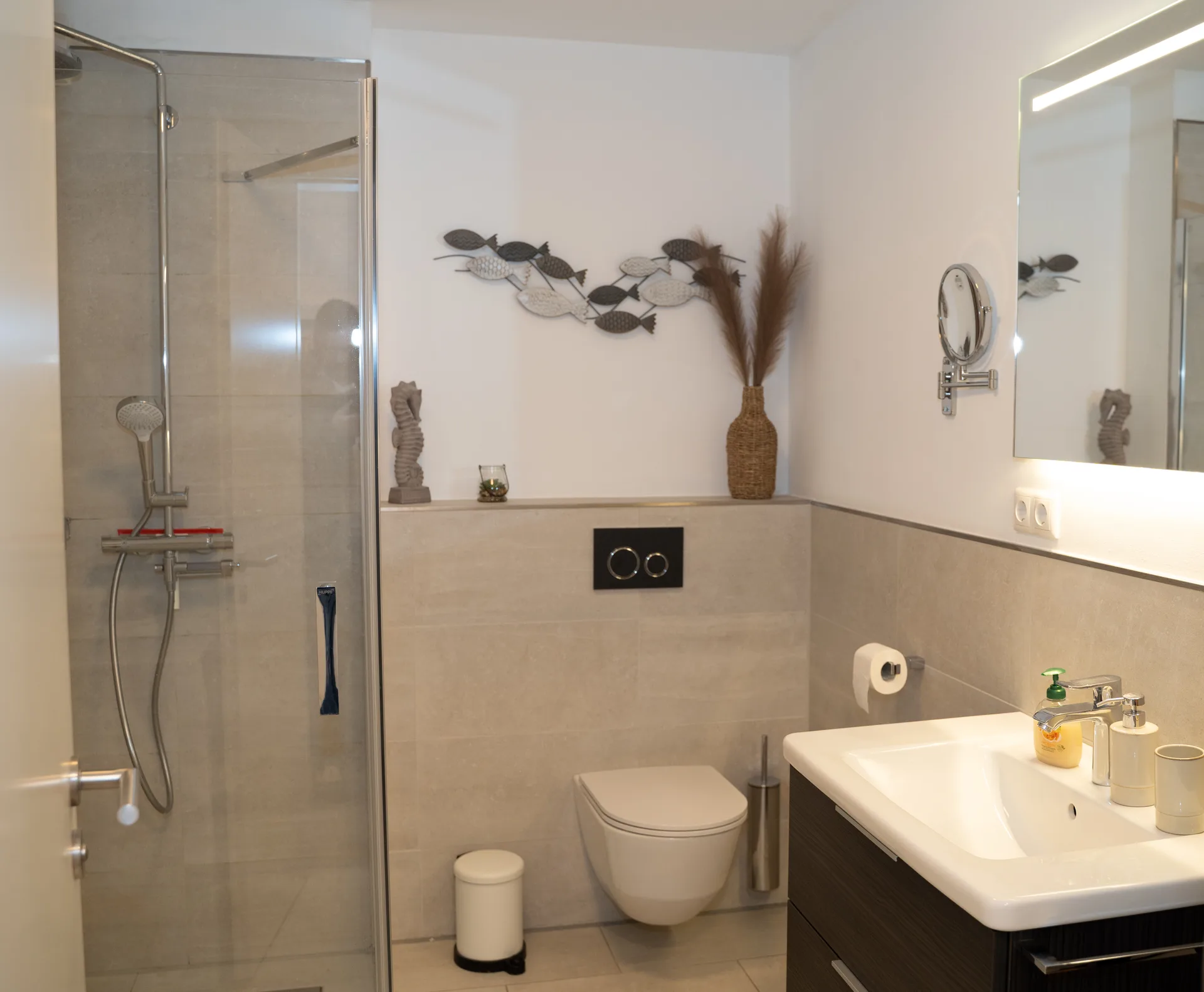 Modernes Badezimmer mit ebenerdiger Dusche, LED-Spiegel und Waschtisch in der Kurparkperle